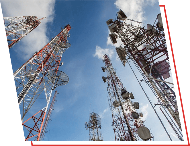 A group of telephones towers with antennas in the sky.