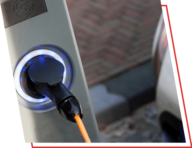 A close up of an electric car charger plugged in