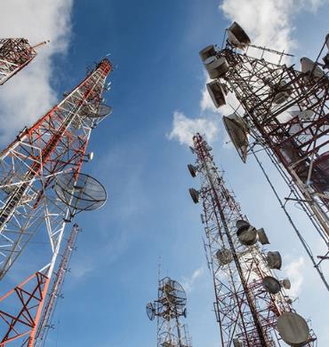Multiple microwave dish towers reaching skyward