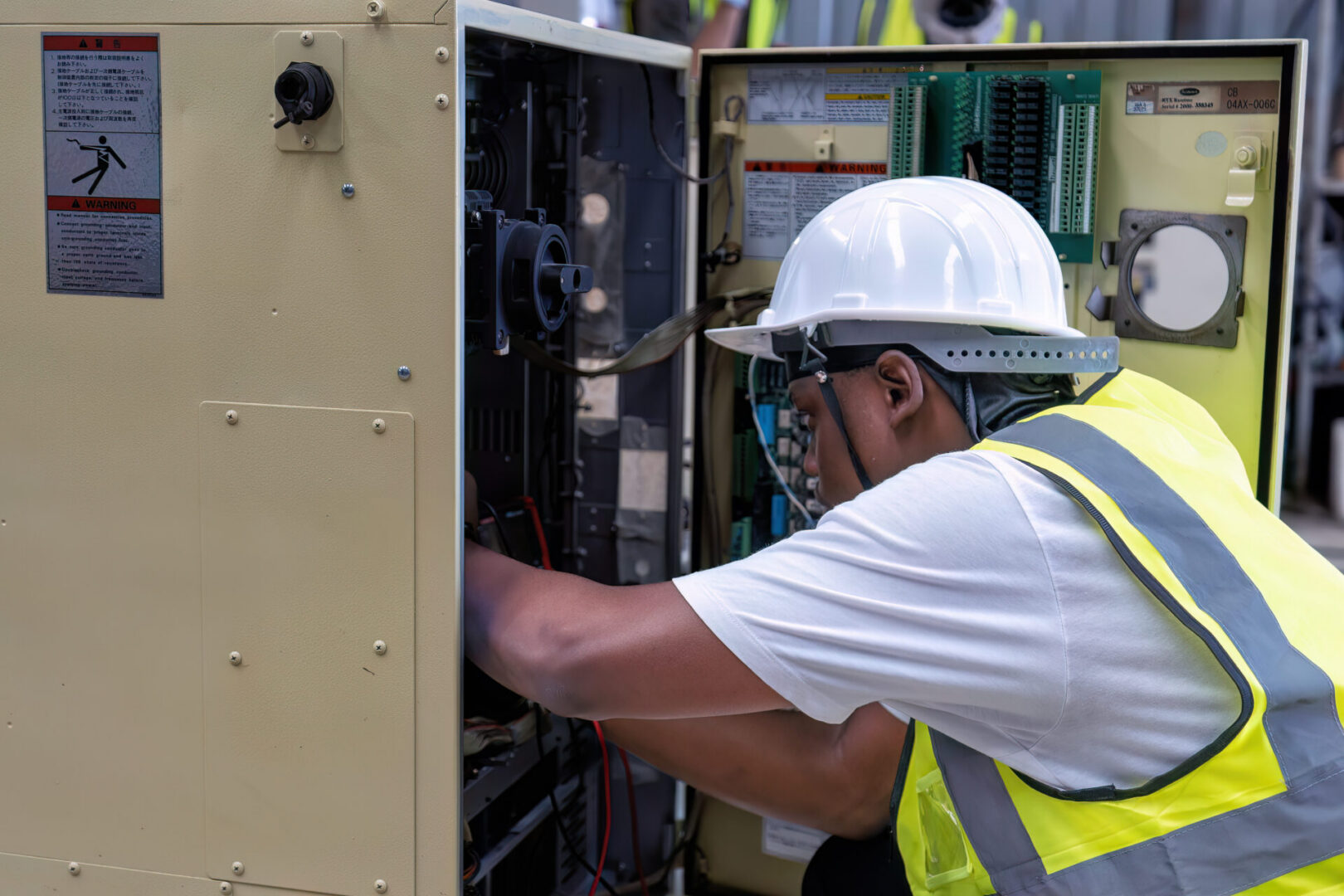 Licensed commercial electrical contractor evaluating panel capacity and circuit connections during a site walkthrough